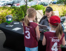 Cindi sponsored a youth softball team.  Here she is accepting a token of appreciation from two of the team members. (Photo: Jeff Boerio)