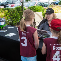 Cindi sponsored a youth softball team.  Here she is accepting a token of appreciation from two of the team members. (Photo: Jeff Boerio)