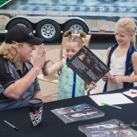 Cindi signs an autograph for a couple of young fans. (Photo: Jeff Boerio)