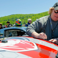 Cindi signs an autograph at Lime Rock. &nbsp;(Photo: Shawn Pierce Photography)