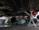 Crew member Robert works under the car. 