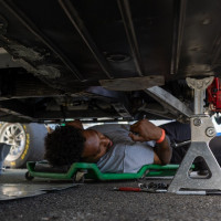 Crew member Robert works under the car. 