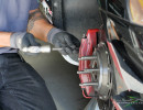 Crew member Robert Montano works on the brakes between sessions (Photo: Chris Clark)