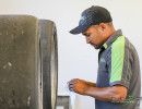 Crew member JP Marais readies tires for the next session (Photo: Chris Clark)