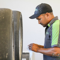 Crew member JP Marais readies tires for the next session (Photo: Chris Clark)